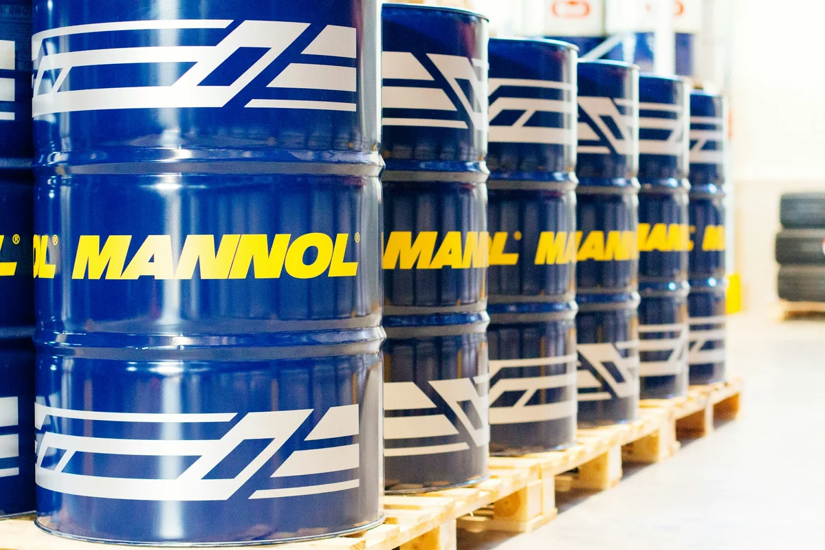 Rows of blue industrial material drums in a warehouse